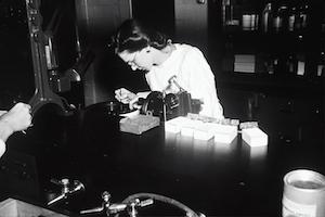 A historic photo of a researcher working in a lab.