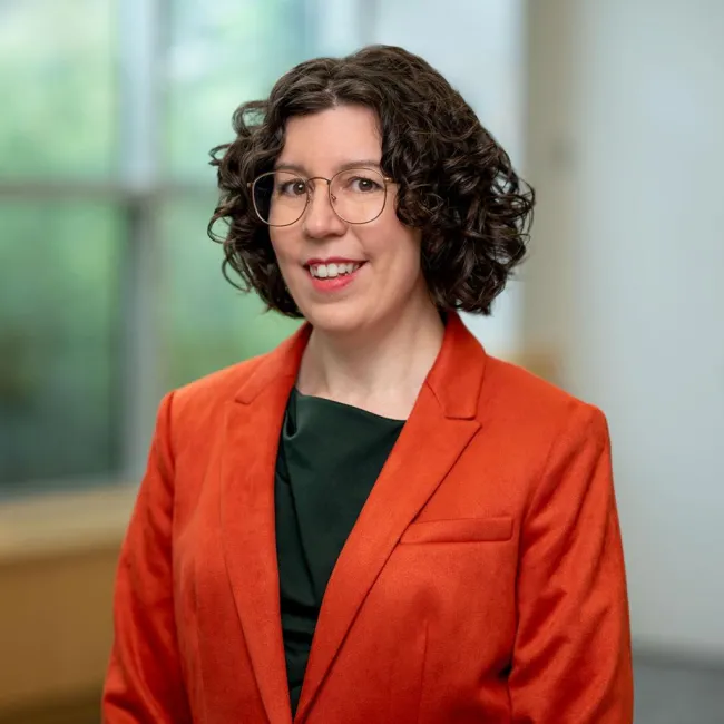 A professional headshot photograph of Lauren Burroughs